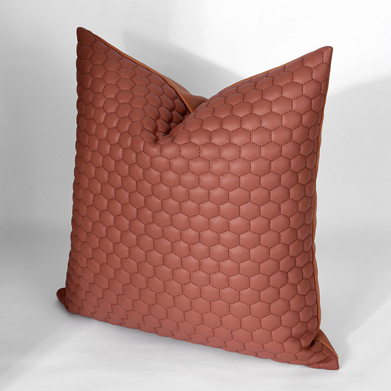 A brown pillow with a hexagon pattern