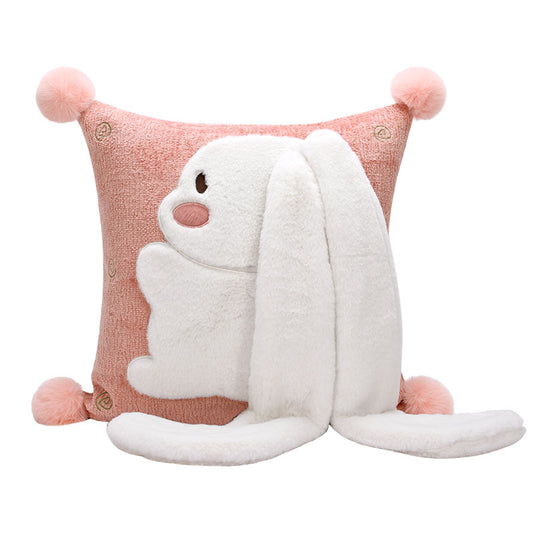 A pink and white pillow with a white and pink animal design