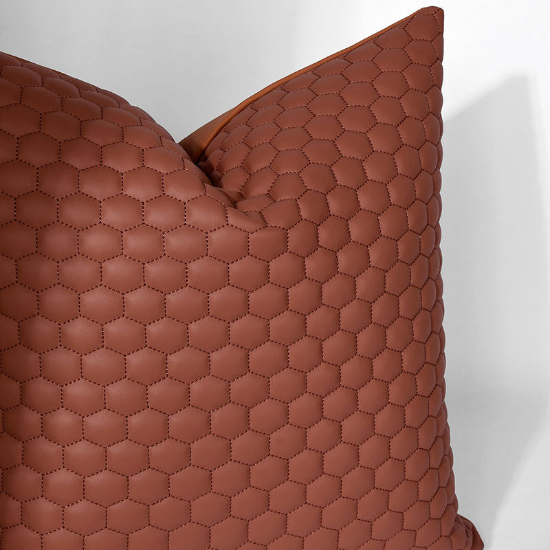 A brown pillow with a hexagon pattern