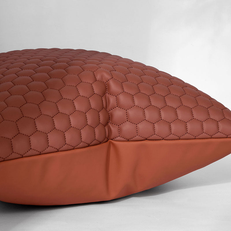 A brown pillow with a hexagon pattern